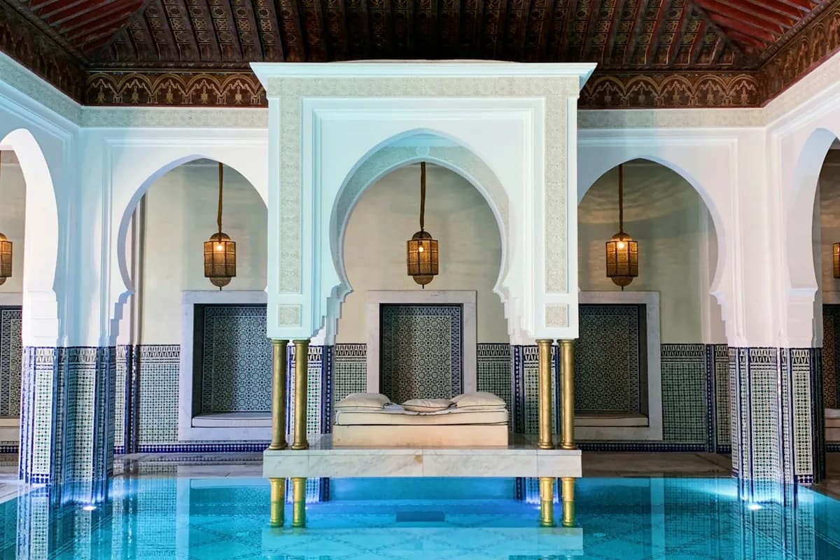 Pool in a courtyard with arches and tilework